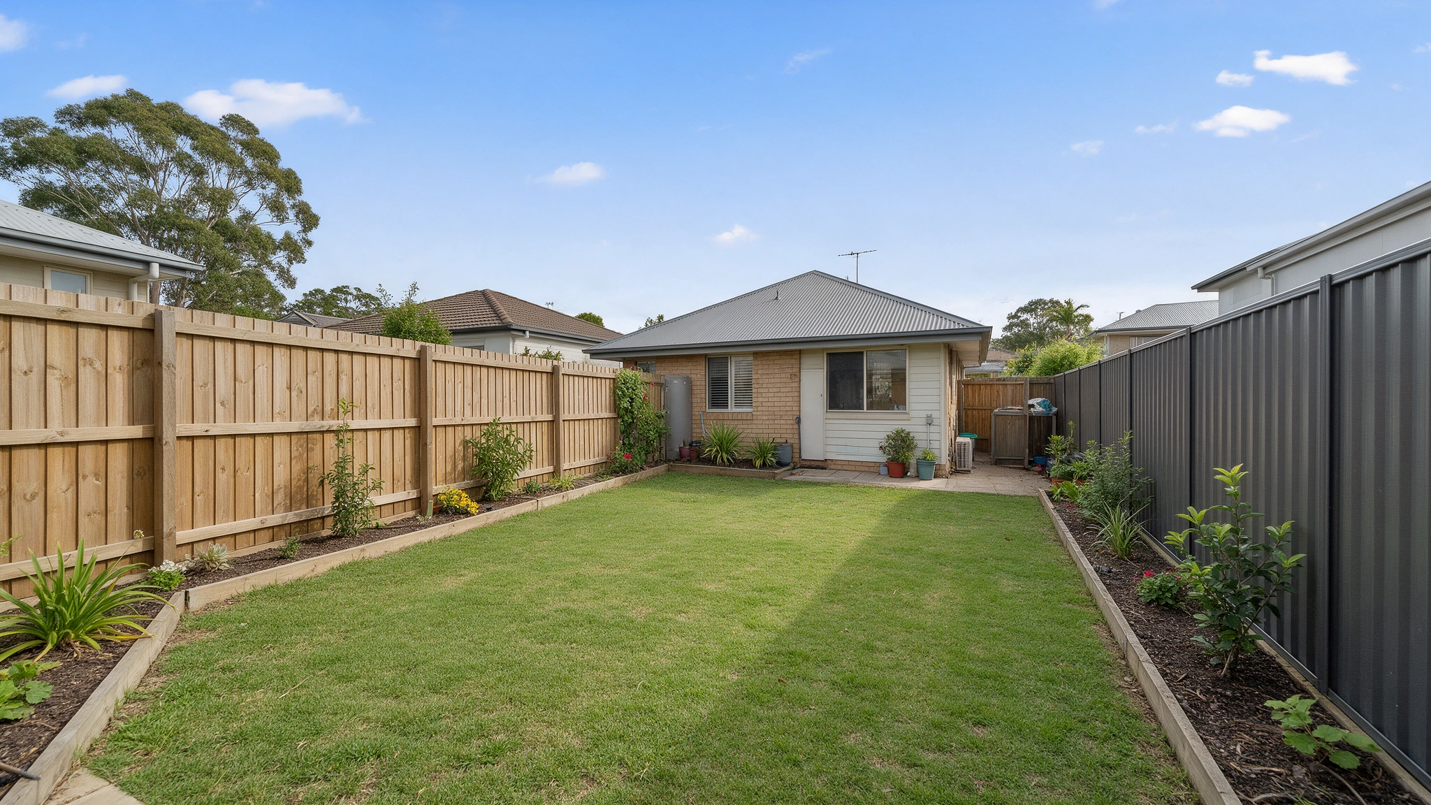 Timber and metal fencing around a suburban backyard